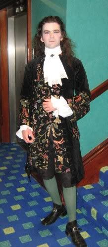 A black velvet frock coat with jacquard woven facings and waistcoat...